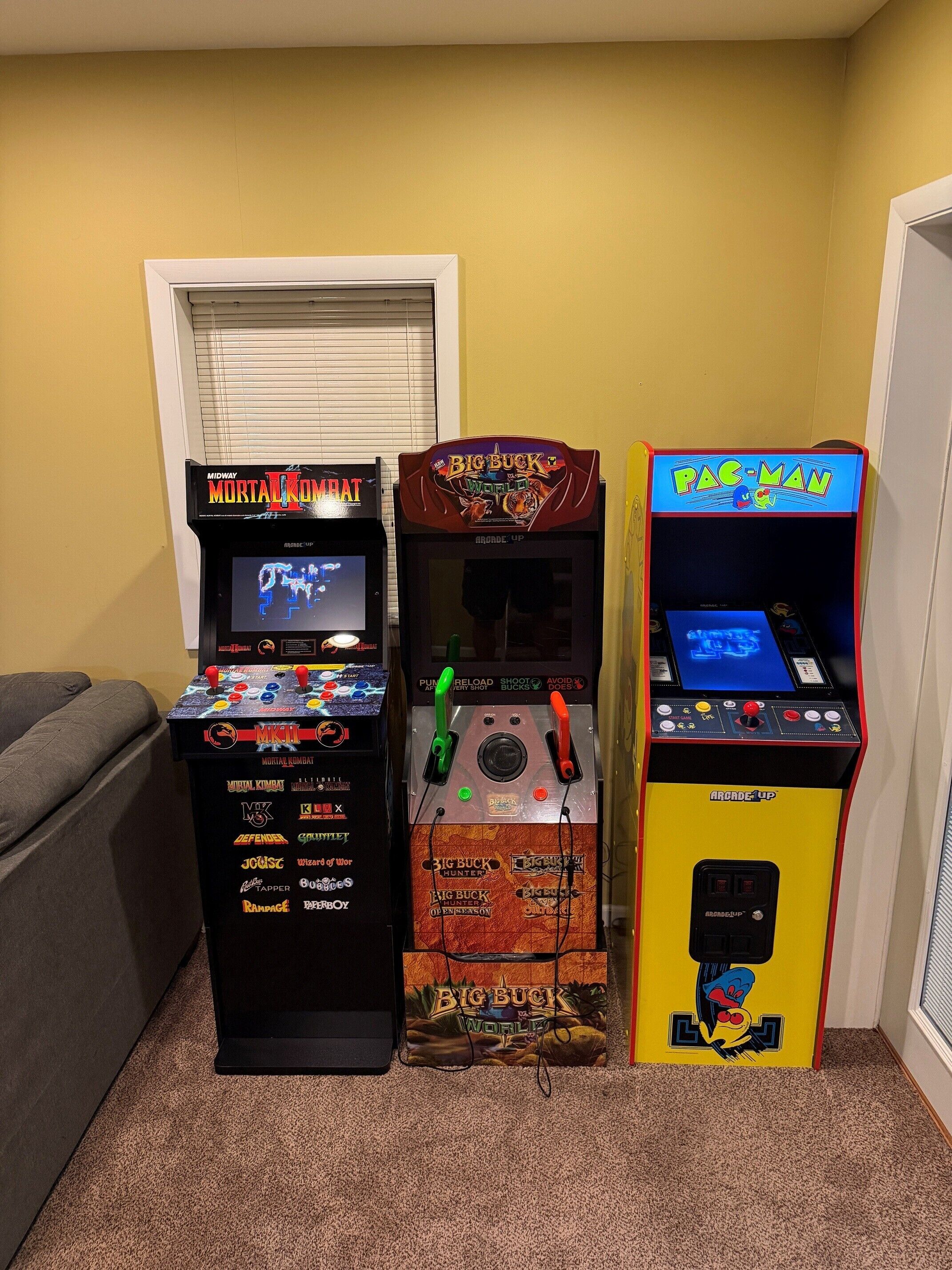 Three arcade machines: Mortal Kombat, Big Buck World, and Pac-Man.