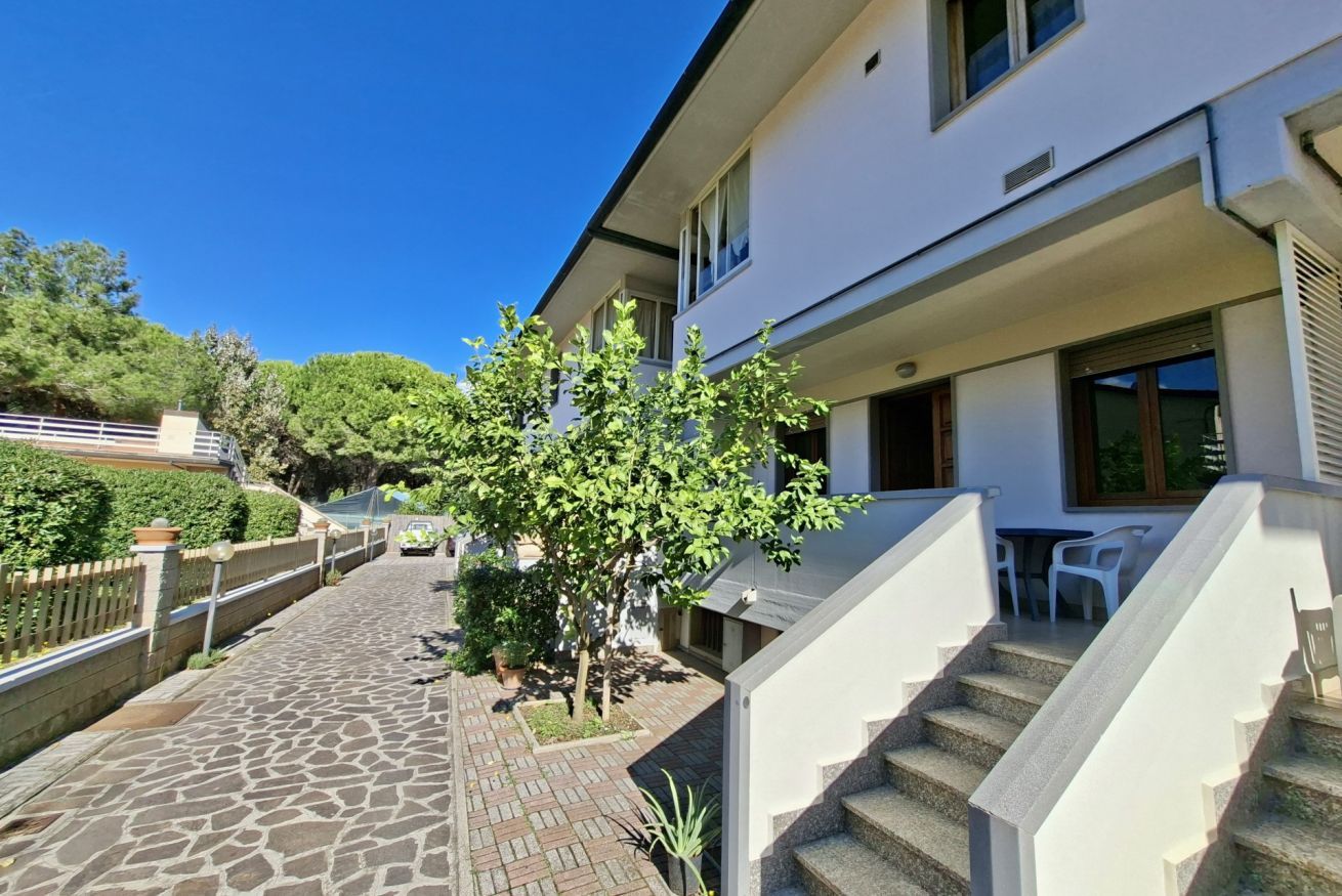 A modern building with a stone pathway leading to a staircase.