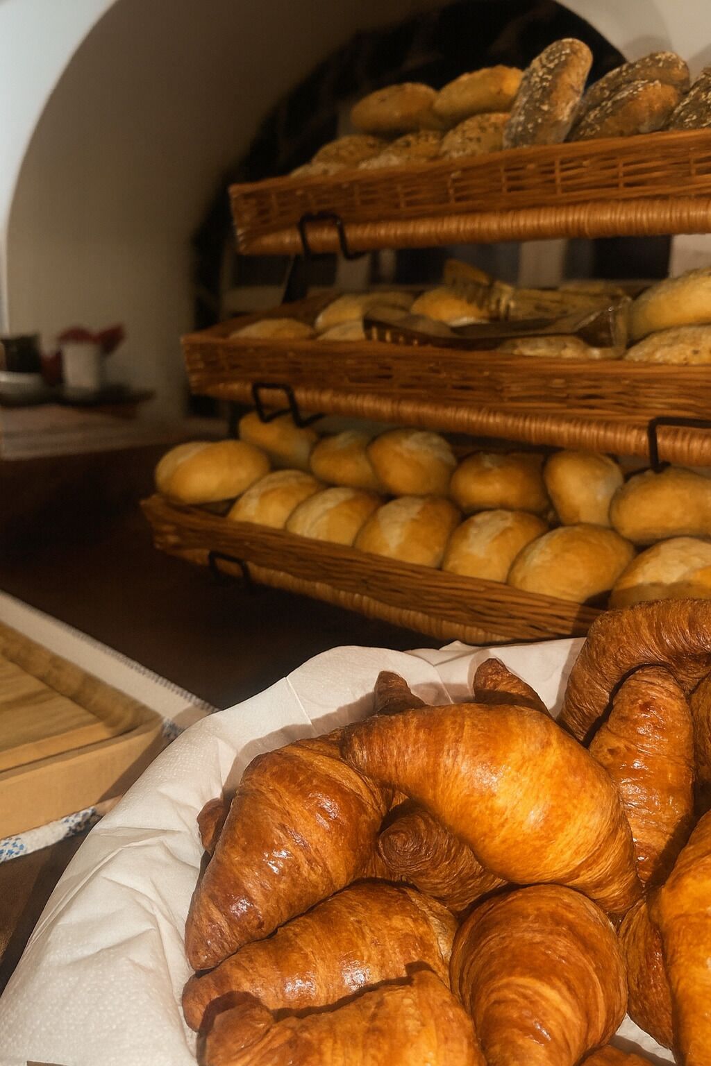 A bakery display with various breads and pastries.