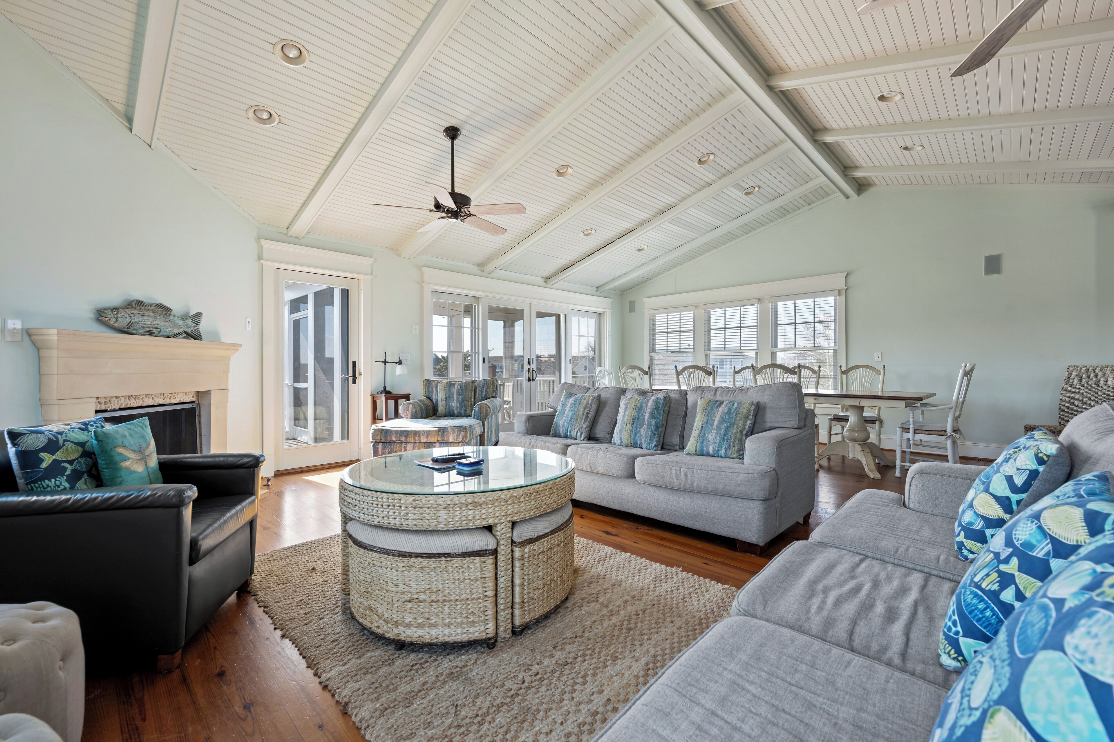 A spacious living room with a high ceiling, a fireplace, and a large window. - FAMILY AFFAIR!  GORGEOUS 7 BR HOME- WALK TO BETHANY BEACH! 104 Third St. (Bethany Beach)