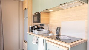 A compact kitchen with a microwave, coffee maker, and a whiteboard. - Cozy chalet for 6 in nature (Aussois)