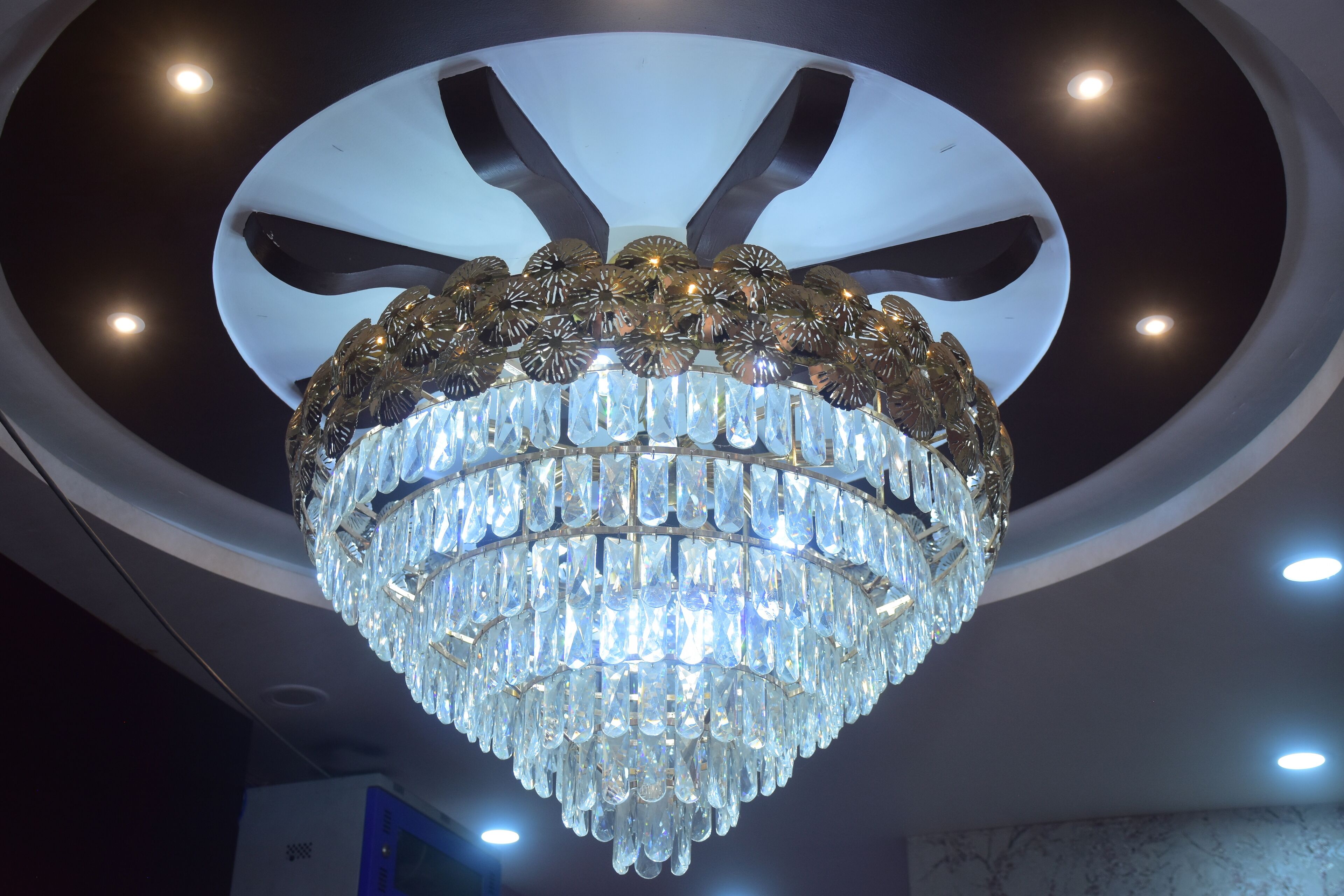 A chandelier with multiple tiers of clear crystal.