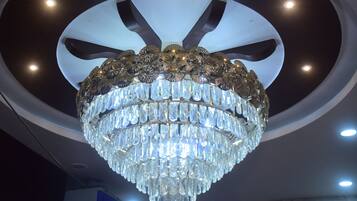 A chandelier with multiple tiers of clear crystal.