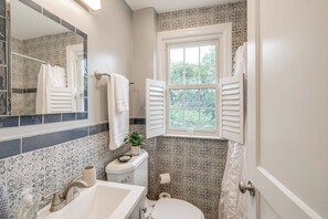 A bathroom with a sink, toilet, and window. - 1 Mi to Old Town Alexandria: Townhome w/ Patio (Alexandria)