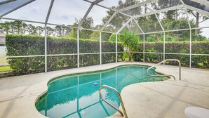 A covered swimming pool with a metal frame, a diving board, and a pool ladder. - 5 Mi to Beaches: Family Getaway in Palm Coast! (Palm Coast)