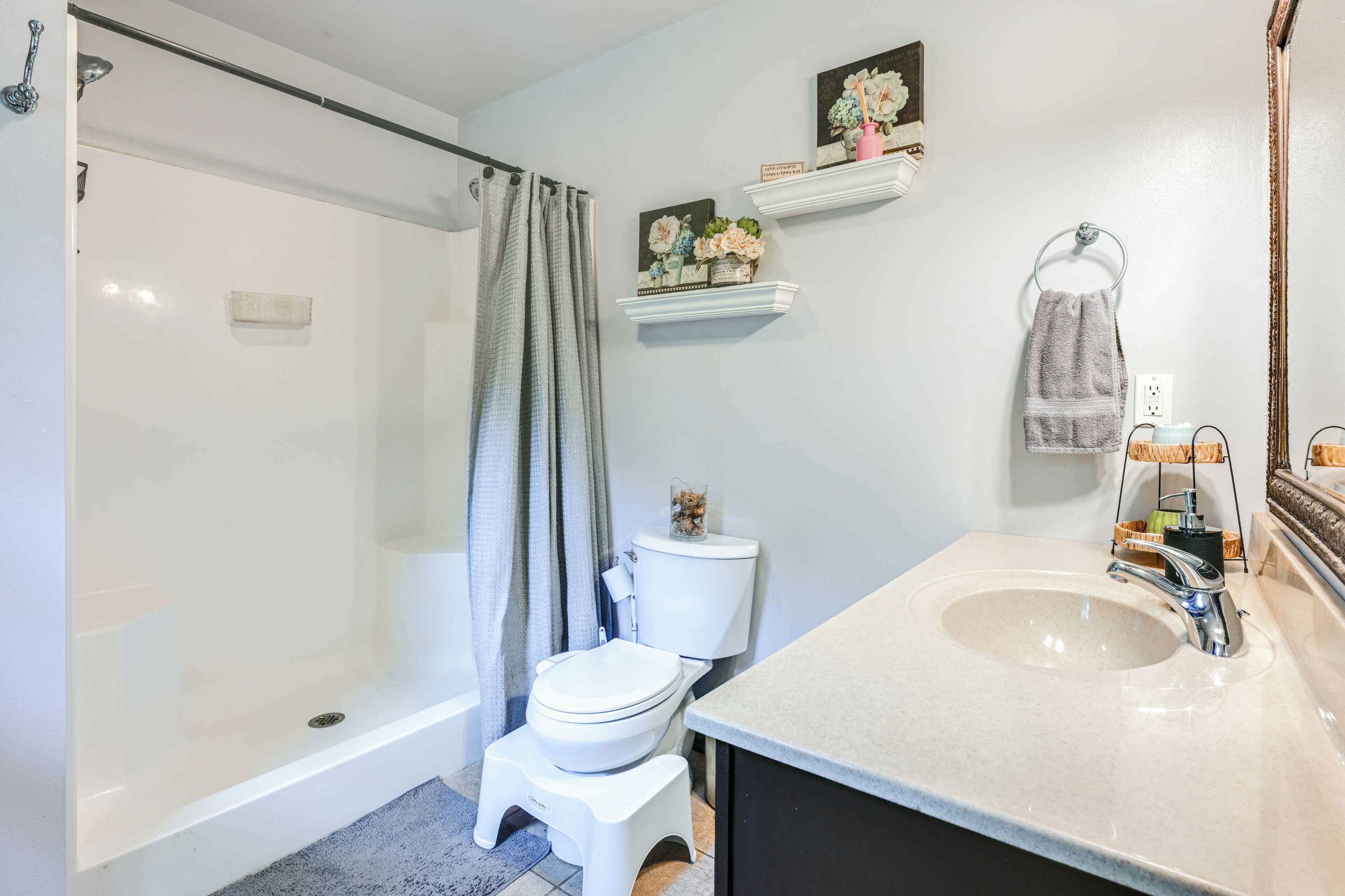 A bathroom with a shower, toilet, and sink.