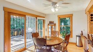 A dining area with a round table, wooden chairs, and a ceiling fan. - Fish, Unplug & Unwind! Countryside Plymouth Home (Plymouth)