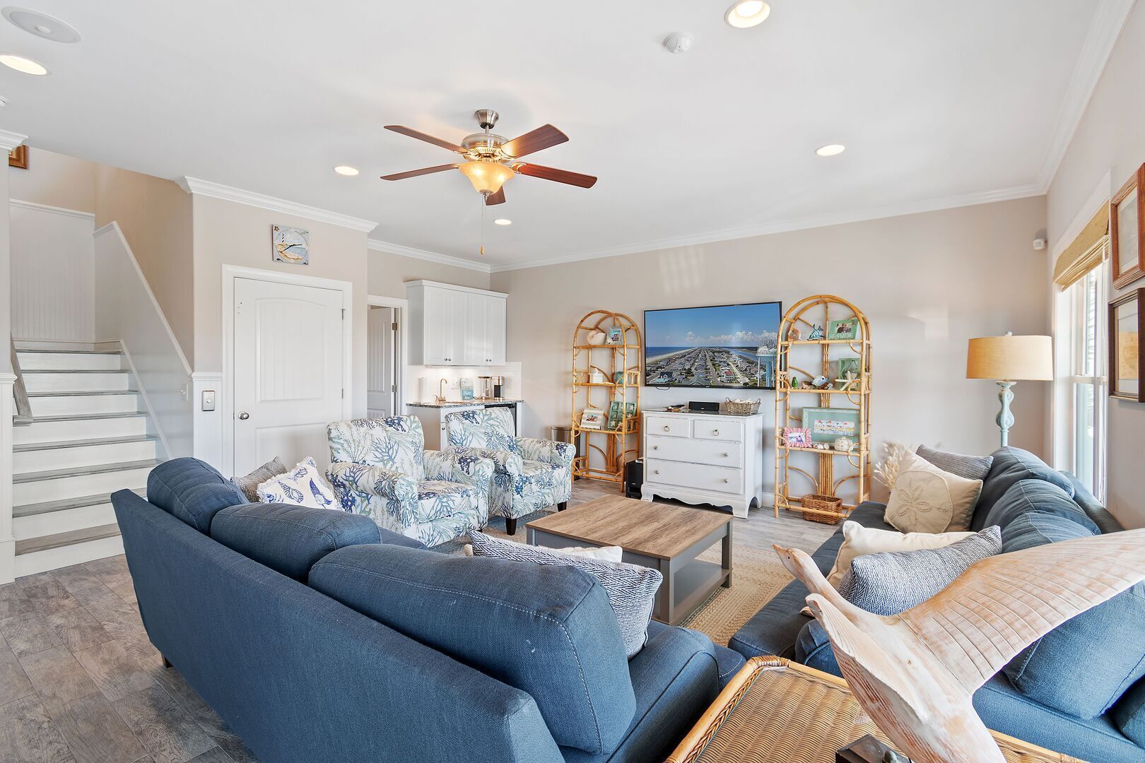 A spacious living room with a sofa set, a coffee table, and a television.
