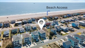 An aerial view of a coastal residential area with houses, a beach, and a marked 'Beach Access' point. - Shrimply The Best -Luxury Holden Beach Home with Private Saltwater Pool, Elevator & Tiki Bar (Holden Beach)