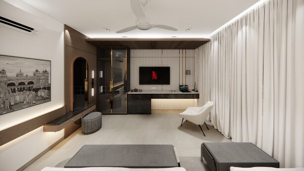 A modern living room with a flat-screen TV, a ceiling fan, a sofa, a coffee table, and a dining area with a kitchen counter. - The White Castle Hotel  (Mysore)