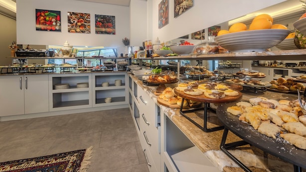 A buffet with various food items and a kitchen area with appliances. - newlifecappadocia (Nevşehir)