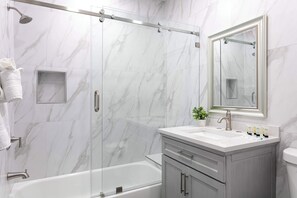 Shower, hair dryer, towels, shampoo