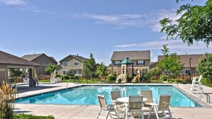 A swimming pool with lounge chairs and a gazebo in a residential area. - Windshire Retreat | Pool, Garage & Pet-Friendly (Windsor)
