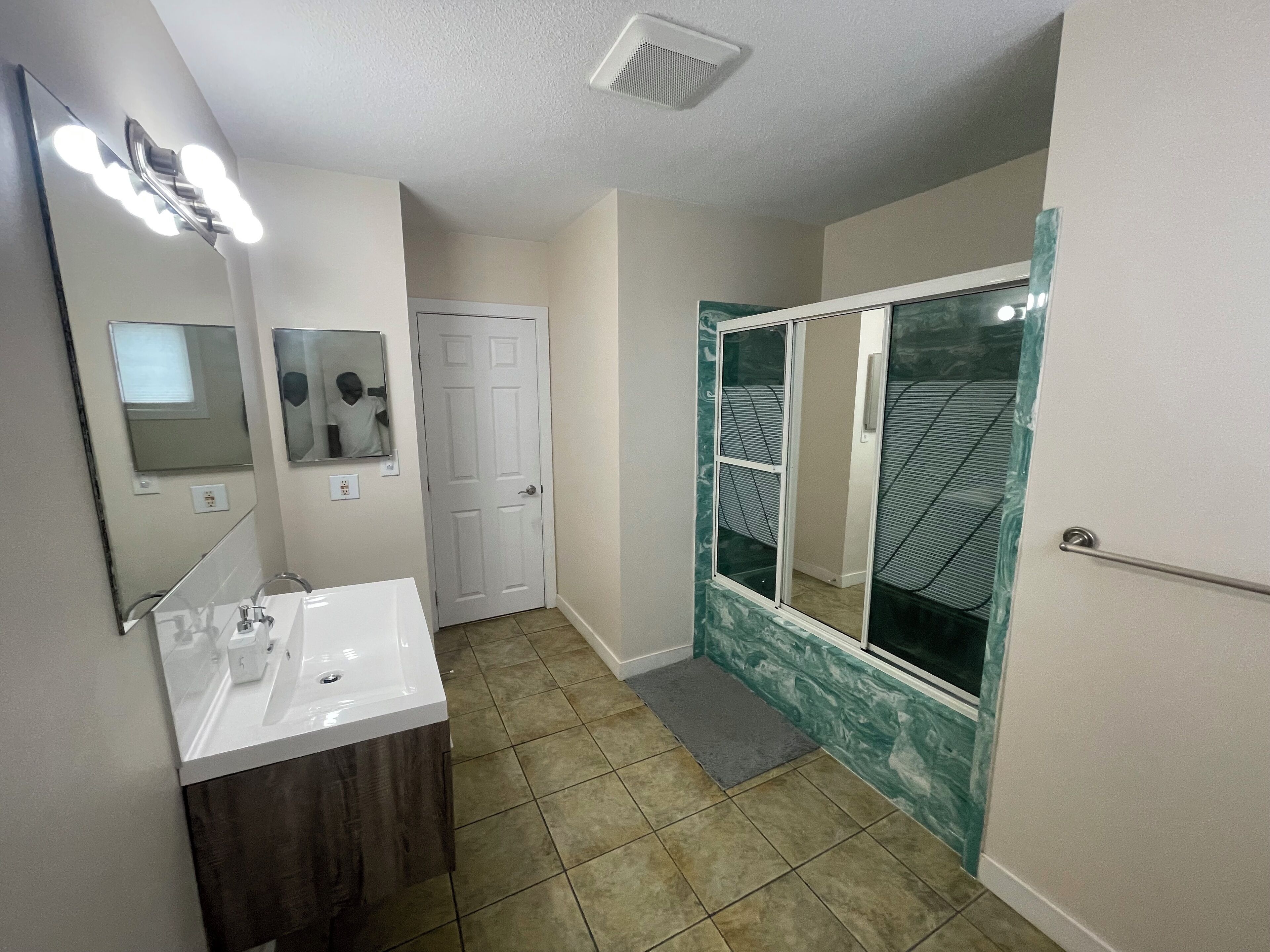 Tina con regadera, secadora de cabello, toallas, jabón 