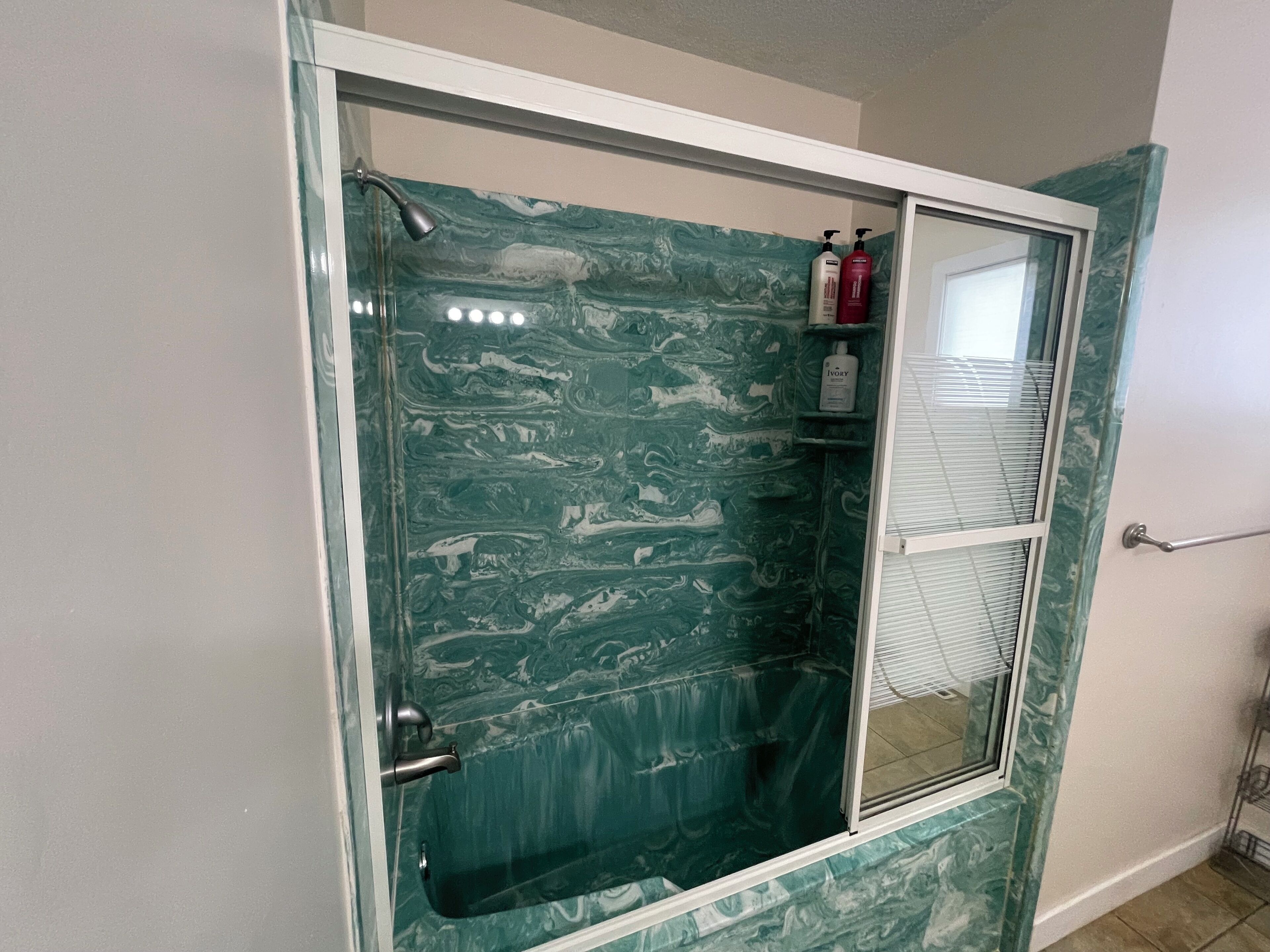 Combined shower/bathtub, hair dryer, towels, soap