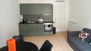 A modern apartment with a dining area, kitchenette, and a living room. - Casa Sforza - stylish apartment in the heart of Bergamo! (Bergamo)