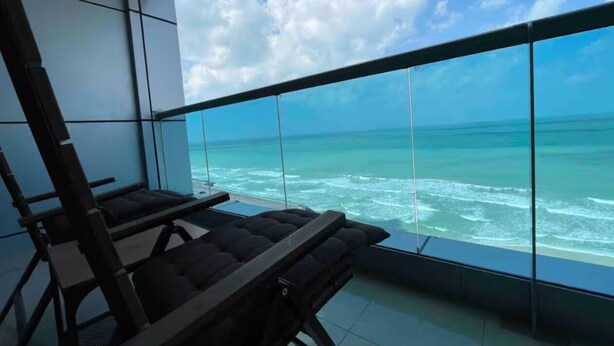 A balcony with a view of the ocean.