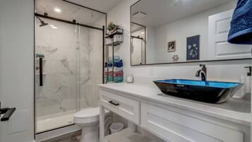 Een douche, handdoeken, zeep, toiletpapier