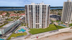 A high-rise hotel with multiple balconies, a pool area, and a beach view. - ☀️ Ocean Front - Sherwin Condominium 1702 ☀️ (Daytona Beach Shores)