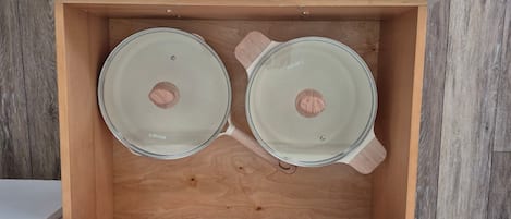 A wooden drawer with two glass containers labeled 'carote'.
