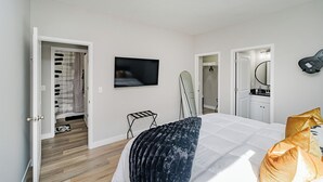 A bedroom with a bed, a television, a guitar, and a mirror. - BRAND NEW Spacious and Uniquely Musical Home near Downtown Indianapolis! (Indianapolis)