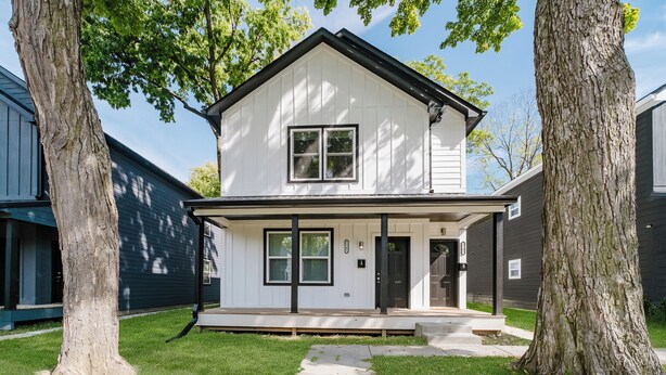 A two-story house with a front porch, a garage, and a driveway. - BRAND NEW Spacious and Uniquely Musical Home near Downtown Indianapolis! (Indianapolis)