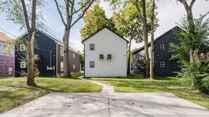 A residential area with a central white house surrounded by trees and other houses. - BRAND NEW Spacious and Uniquely Musical Home near Downtown Indianapolis! (Indianapolis)