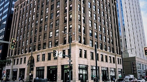 A multi-story building with a classic architectural style, featuring a prominent corner entrance and large windows. - The Lofty Loft - True City Living in Downtown Denver (Denver)