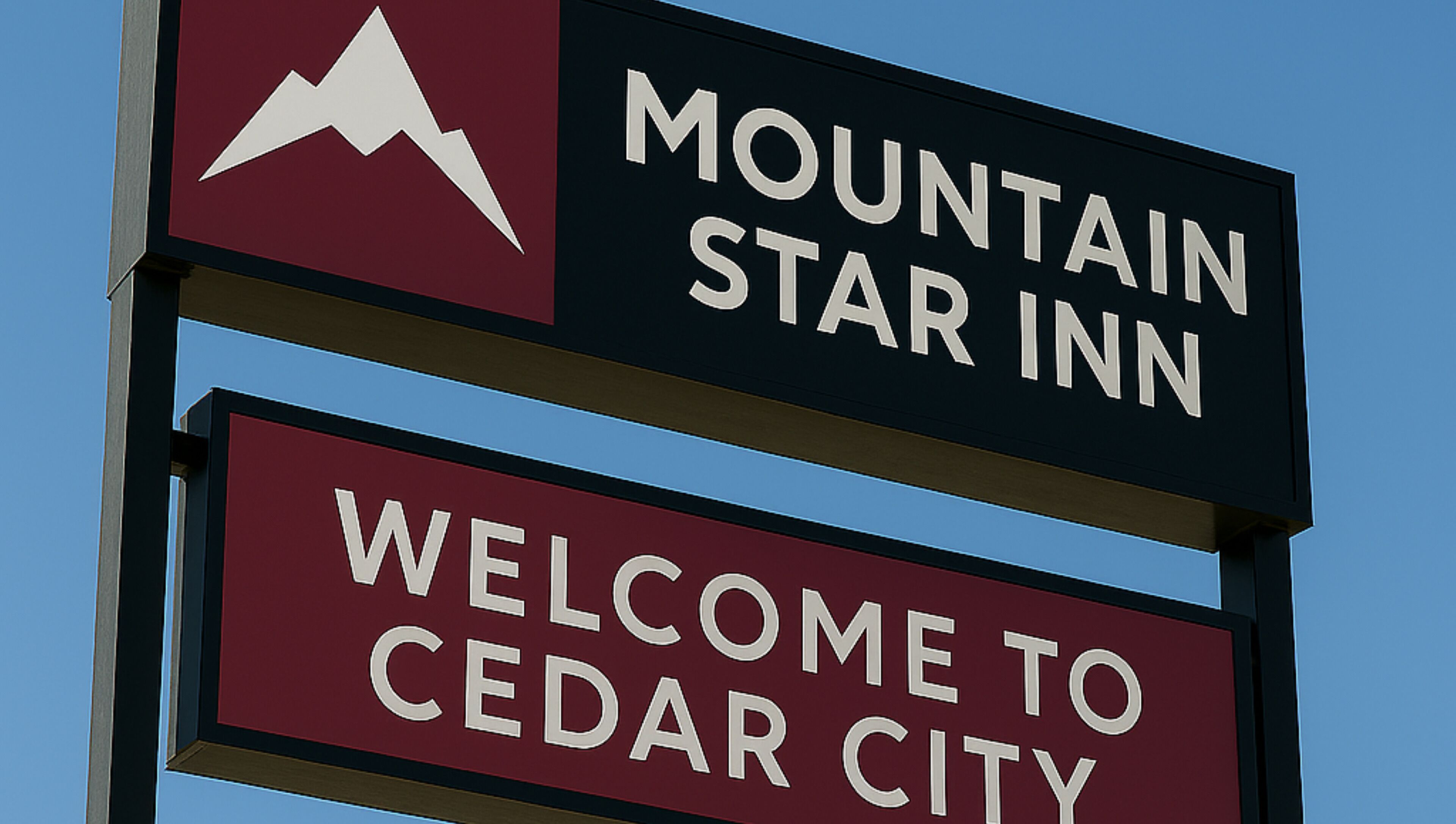 A sign with "Mountain Star Inn" and "Welcome to Cedar City" text.