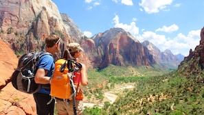A mountainous landscape with hikers.