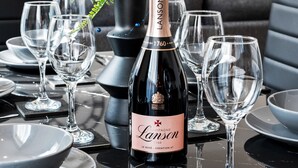 A dining table set with wine glasses, plates, and a bottle of champagne. - Stylish 2 Bed Apartment Central Brighton, The Lanes Sleeps 8 (Brighton and Hove)