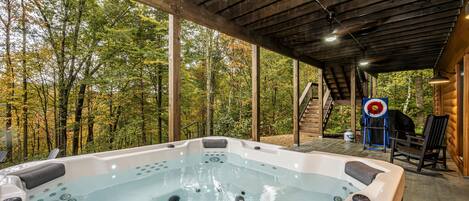 Secluded covered patio with a relaxing hot tub retreat