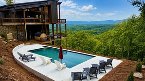 A modern house with a pool, outdoor seating, and a scenic view. - NEW! Heated Pool + Sauna + Dog-Friendly (Mineral Bluff)
