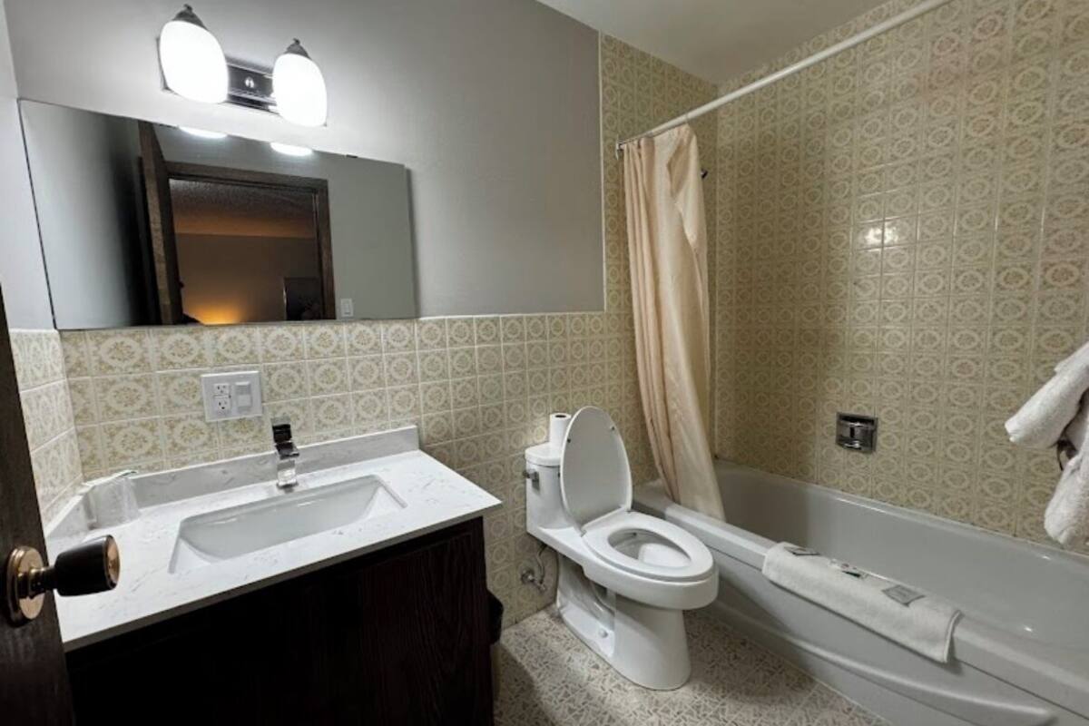 A bathroom with a sink, toilet, and bathtub.