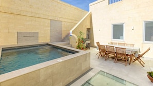 A swimming pool with a hot tub, outdoor seating, and a staircase leading to a balcony. - Authentic Charming Farmhouse With Pool in Gozo (Zebbug)