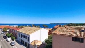A coastal town with buildings, a clear blue sky, and the sea in the background. - La Marjolaine by Interhome (Sainte Maxime)