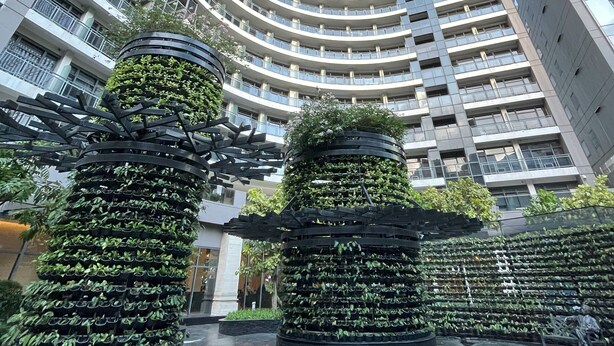 A modern high-rise building with a curved facade and multiple balconies.