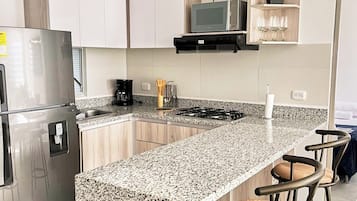 Full-size fridge, microwave, cookware/dishes/utensils