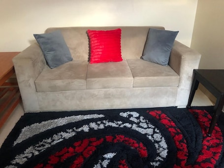 Deluxe Apartment | Living area | 32-inch Smart TV with digital channels