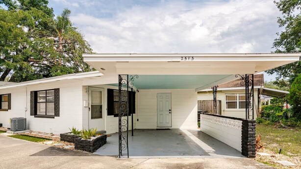 A single-story house with a covered garage, a front door, and a mailbox. - Updated 2 BR / 5 min to Advent Health / Walk to Museums, Parks & Dining. (Orlando)