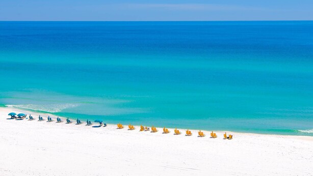 A beach with rows of sun loungers and umbrellas. - Arcadia Sands: Private Beach, Ocean Views, Pool & Hot tub, Game Room, Bunk Rooms (Miramar Beach)