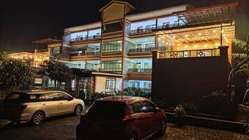 A multi-story hotel with balconies and a covered outdoor area.