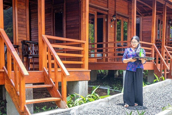 A wooden structure with a staircase and a person holding a tray. - Shankara Forest Haven Villa by AGATA (Penebel)