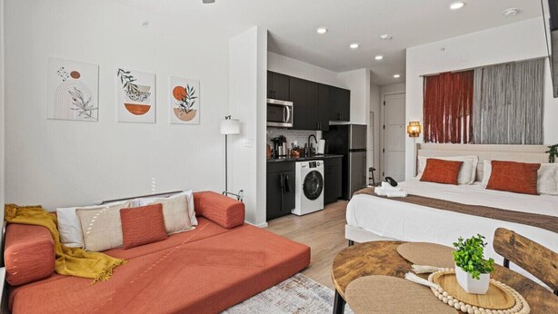 A modern apartment with a living room, kitchenette, and a bedroom. - Trendy Bishop Arts | Game Room + Gym + Yoga (Dallas)