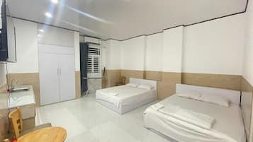 Executive Quadruple Room | In-room safe, desk, laptop workspace, blackout curtains