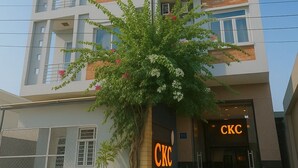 A multi-story building with balconies, a prominent 'CKC' sign, and a tree in front. - CKC 24H Hotel Near Can Tho City Center (Can Tho)