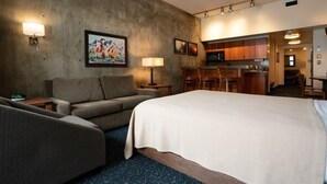 A hotel room with a bed, a sofa, a desk, a lamp, and a painting on the wall. - Ski-in-ski-out Snowbird, X-large studio, Alta, LCC Hot Tub, Heated Pool (Snowbird)