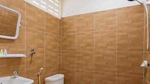 A bathroom with a toilet, sink, and shower. - Sundiva Guest House (Patong)