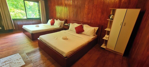A room with two beds, wooden flooring, a wardrobe, and a window with curtains. - Sun&Roots Lodge Restaurant and Bar (Kampot)