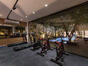 A gym with treadmills, stationary bikes, and a pool area. - 22 By Spacey (#52) | Studio in Maadi (Cairo)